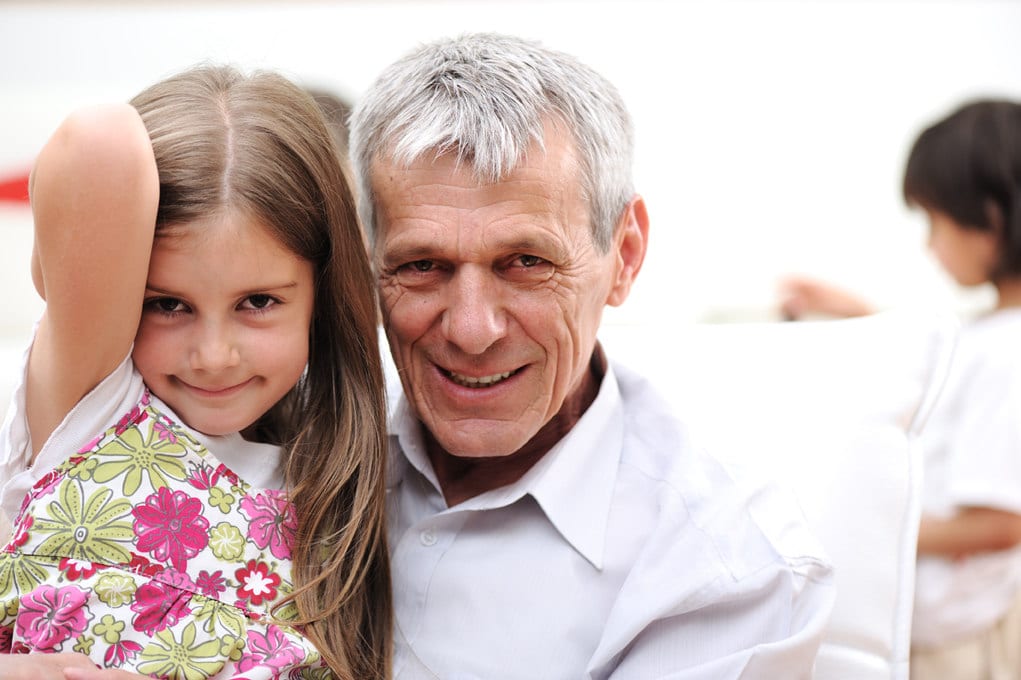 Grandfather with children, senior man at home with family